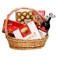Basket with sweets and wine